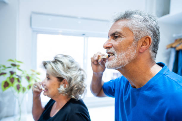 senior couple brushing their teeth